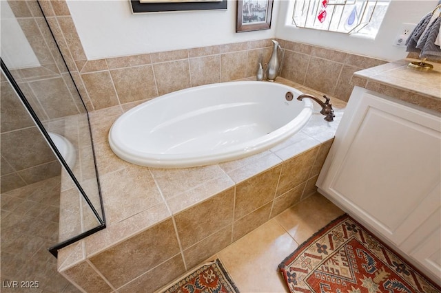 7209 Millerbird St, North Las Vegas, NV 89084 - bathroom featuring a garden tub, vanity, tiled shower, and tile patterned flooring