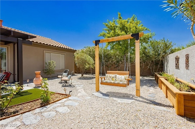 7209 Millerbird St, North Las Vegas, NV 89084 - fenced backyard with a patio area and a vegetable garden