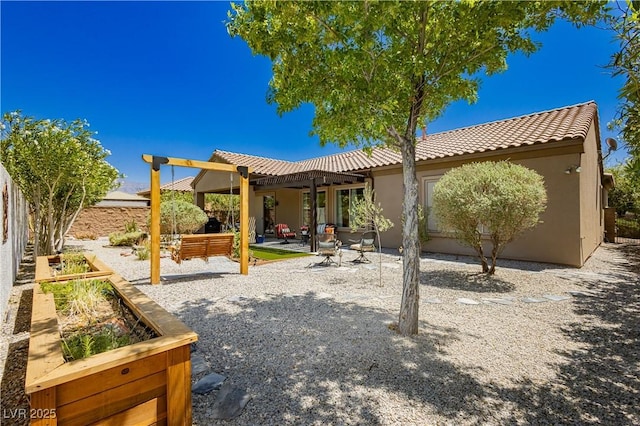 7209 Millerbird St, North Las Vegas, NV 89084 - rear view of property with a pergola, stucco siding, a patio, and a tiled roof