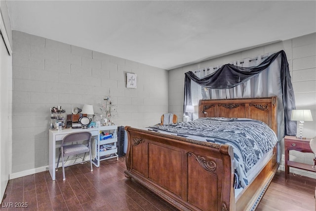 1037 Westminster Ave, Las Vegas, NV 89119 - bedroom with dark wood-type flooring and concrete block wall