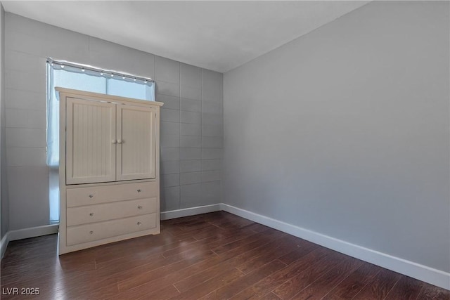 1037 Westminster Ave, Las Vegas, NV 89119 - unfurnished bedroom featuring dark wood-type flooring and baseboards