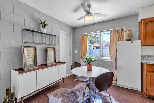 1037 Westminster Ave, Las Vegas, NV 89119 - dining room featuring dark wood finished floors, a ceiling fan, and concrete block wall