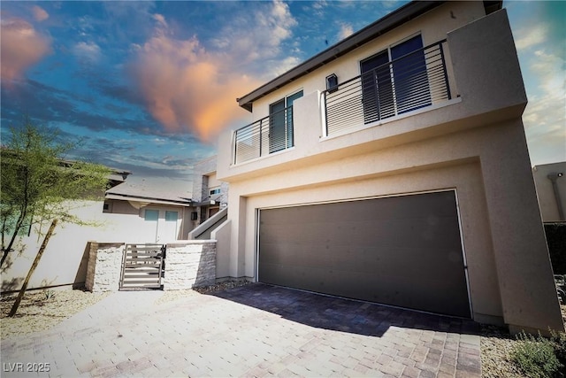 4182 Solace St, Las Vegas, NV 89135 - view of property exterior featuring stucco siding, a garage, and driveway