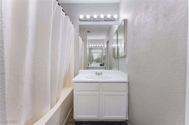 5243 Edna Crane Ave, North Las Vegas, NV 89031 - full bathroom with vanity, shower / bath combo, and a textured wall