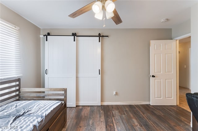 5243 Edna Crane Ave, North Las Vegas, NV 89031 - bedroom with dark wood-style floors, a barn door, multiple windows, and a ceiling fan
