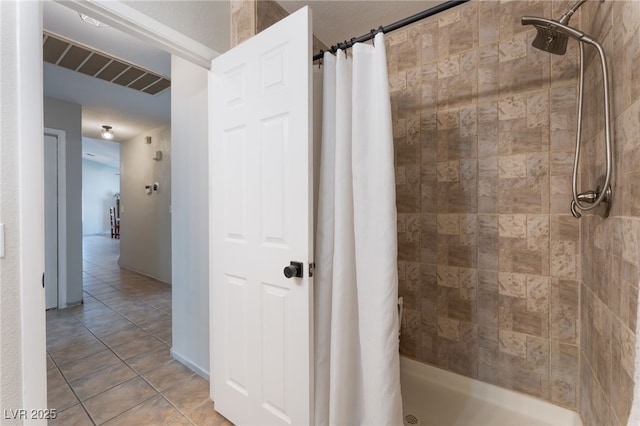 5243 Edna Crane Ave, North Las Vegas, NV 89031 - bathroom featuring a tile shower and tile patterned floors