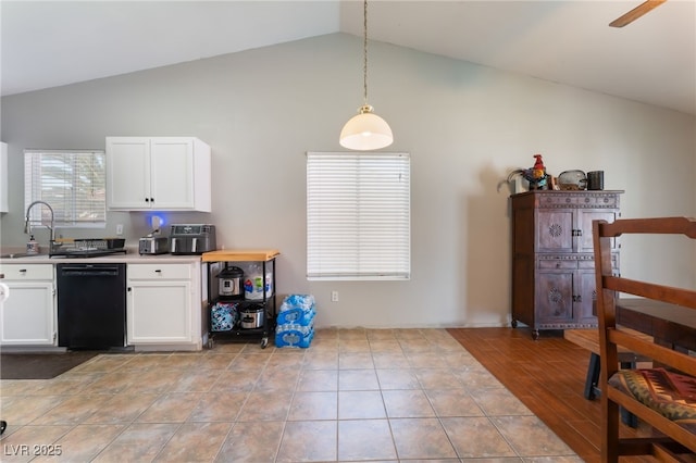 5243 Edna Crane Ave, North Las Vegas, NV 89031 - kitchen featuring dishwasher, lofted ceiling, white cabinetry, light countertops, and hanging light fixtures