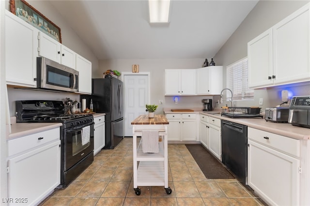 5243 Edna Crane Ave, North Las Vegas, NV 89031 - kitchen with black appliances, white cabinetry, butcher block countertops, and light tile patterned floors