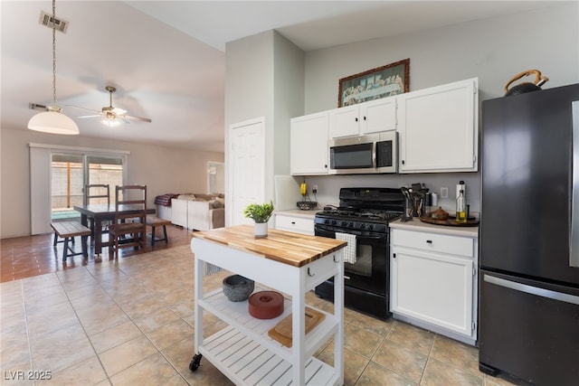 5243 Edna Crane Ave, North Las Vegas, NV 89031 - kitchen featuring black appliances, ceiling fan, white cabinets, light tile patterned floors, and butcher block counters