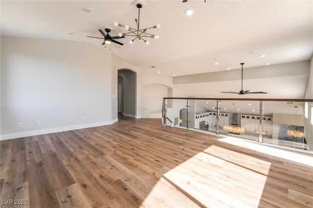 1016 Eaglewood Dr, Las Vegas, NV 89144 - unfurnished living room with arched walkways, ceiling fan, recessed lighting, vaulted ceiling, and a chandelier