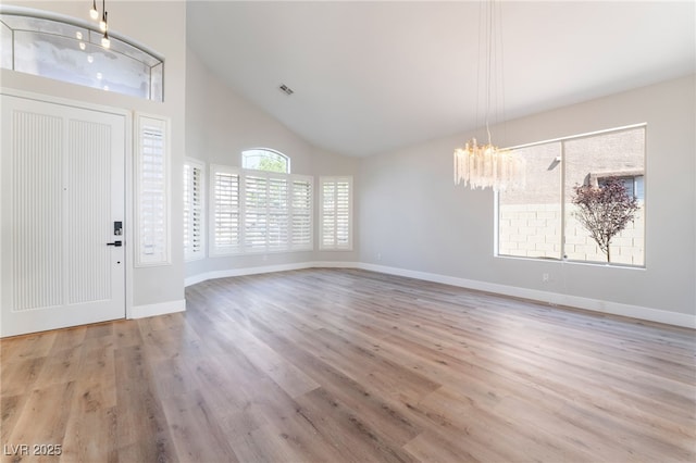 1016 Eaglewood Dr, Las Vegas, NV 89144 - foyer entrance featuring a chandelier, high vaulted ceiling, and wood finished floors