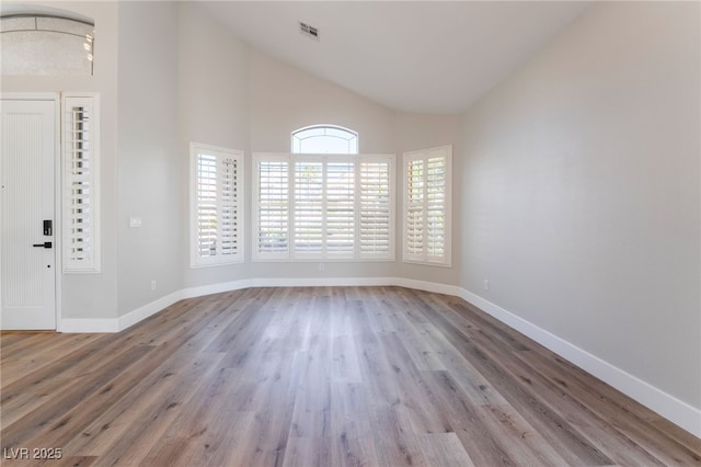 1016 Eaglewood Dr, Las Vegas, NV 89144 - empty room with wood finished floors and high vaulted ceiling