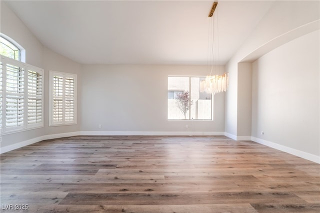 1016 Eaglewood Dr, Las Vegas, NV 89144 - empty room with a chandelier and wood finished floors