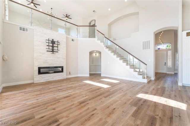 1016 Eaglewood Dr, Las Vegas, NV 89144 - unfurnished living room with ceiling fan, a high ceiling, arched walkways, healthy amount of natural light, and recessed lighting