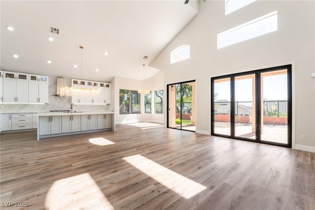 1016 Eaglewood Dr, Las Vegas, NV 89144 - unfurnished living room featuring a high ceiling, light wood finished floors, and recessed lighting