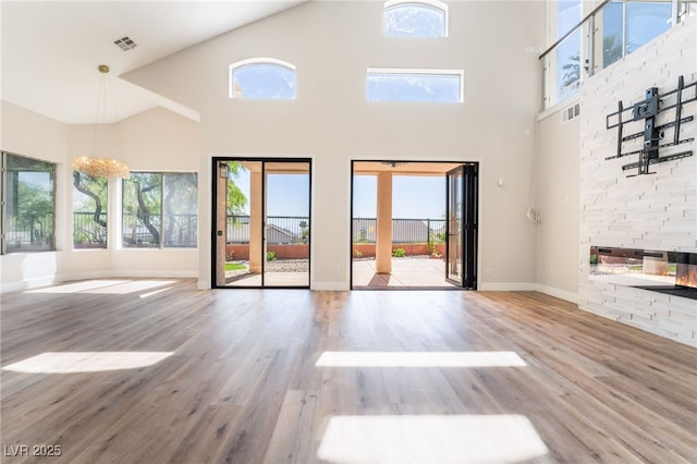 1016 Eaglewood Dr, Las Vegas, NV 89144 - unfurnished living room featuring high vaulted ceiling and wood finished floors