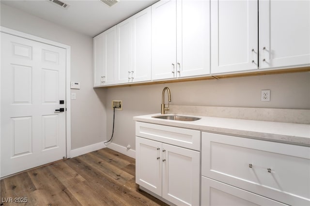 1016 Eaglewood Dr, Las Vegas, NV 89144 - laundry area featuring cabinet space, hookup for a washing machine, and wood finished floors