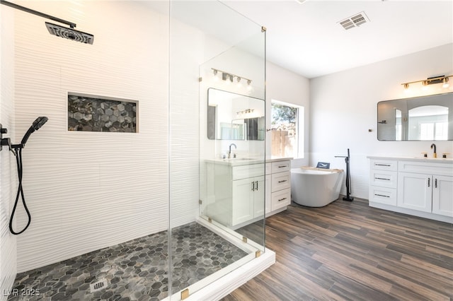 1016 Eaglewood Dr, Las Vegas, NV 89144 - full bath with a shower stall, vanity, a freestanding bath, and wood finished floors