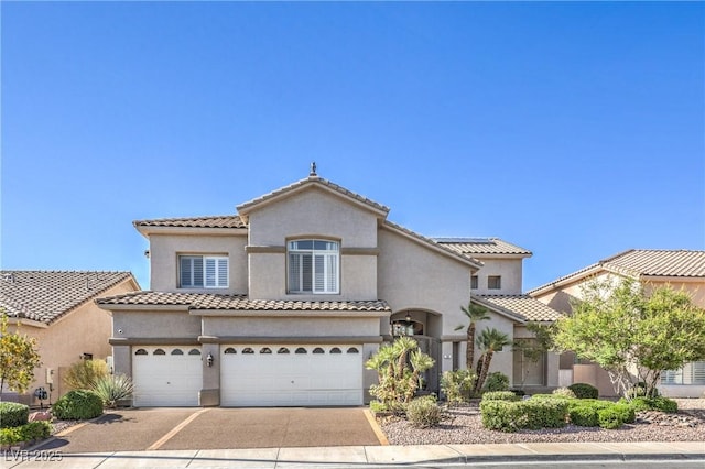 56 Ancient Hills Ln, Henderson, NV 89074 - mediterranean / spanish-style home featuring driveway, a garage, stucco siding, and a tile roof