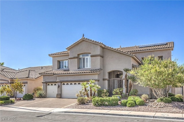 56 Ancient Hills Ln, Henderson, NV 89074 - mediterranean / spanish home with an attached garage, stucco siding, and a tiled roof