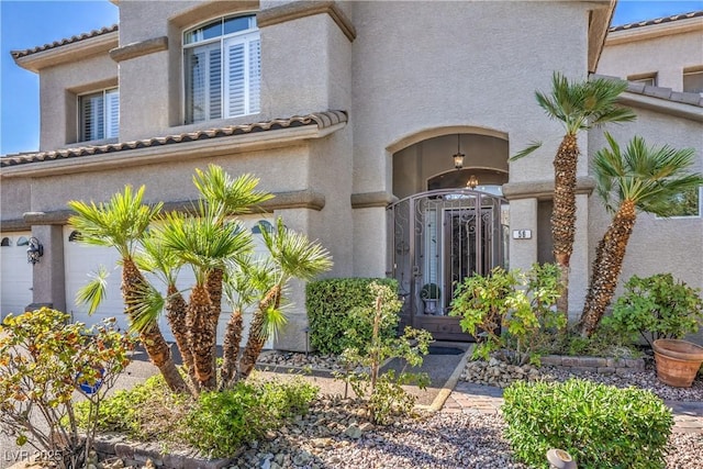 56 Ancient Hills Ln, Henderson, NV 89074 - property entrance with stucco siding and a tile roof