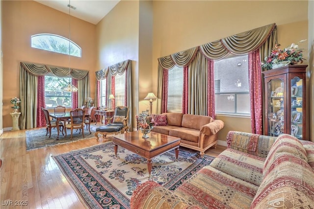56 Ancient Hills Ln, Henderson, NV 89074 - living area featuring a towering ceiling and hardwood / wood-style flooring