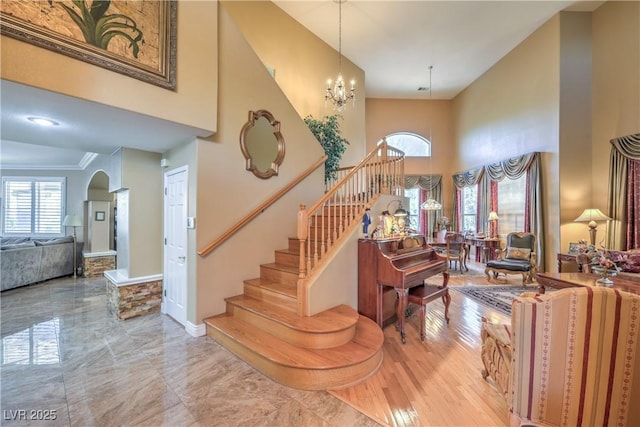 56 Ancient Hills Ln, Henderson, NV 89074 - entrance foyer with healthy amount of natural light, a high ceiling, arched walkways, stairway, and ornamental molding