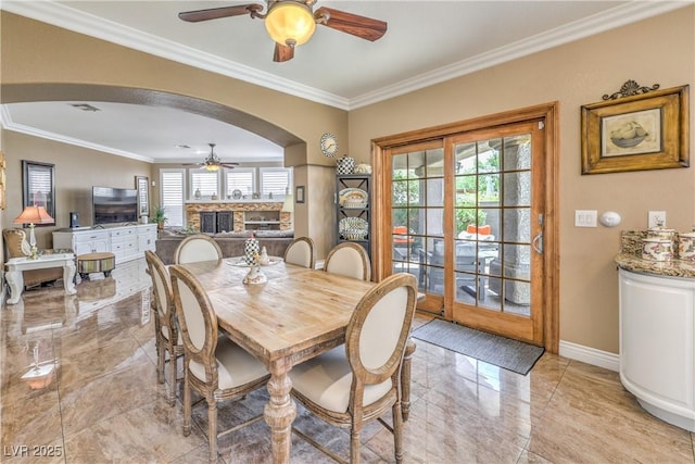 56 Ancient Hills Ln, Henderson, NV 89074 - dining space with a ceiling fan, arched walkways, and ornamental molding