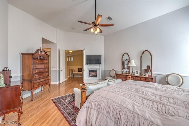 56 Ancient Hills Ln, Henderson, NV 89074 - bedroom with light wood finished floors and ceiling fan