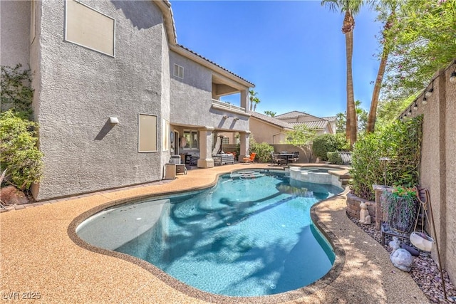 56 Ancient Hills Ln, Henderson, NV 89074 - view of swimming pool with a patio area, a pool with connected hot tub, and a fenced backyard