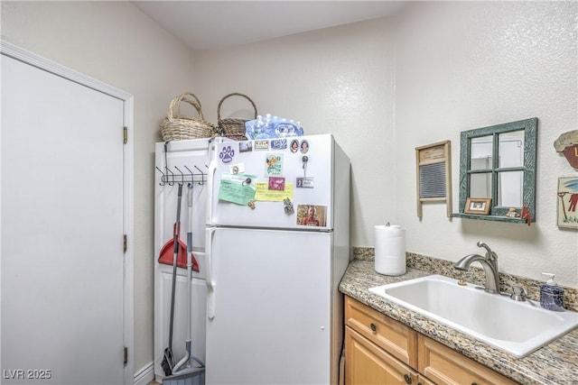 56 Ancient Hills Ln, Henderson, NV 89074 - kitchen with freestanding refrigerator and light countertops