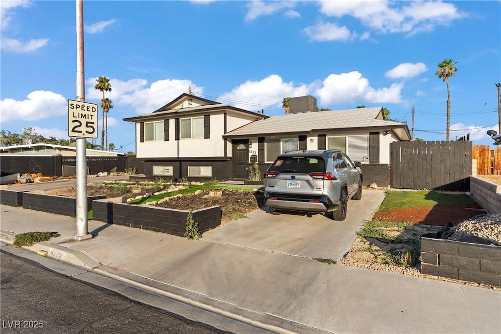6233 Elton Ave, Las Vegas, NV 89107 - split level home featuring concrete driveway and a vegetable garden