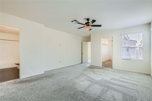 2670 Mango Light Ave, North Las Vegas, NV 89086 - unfurnished bedroom featuring carpet flooring, a spacious closet, connected bathroom, and a ceiling fan