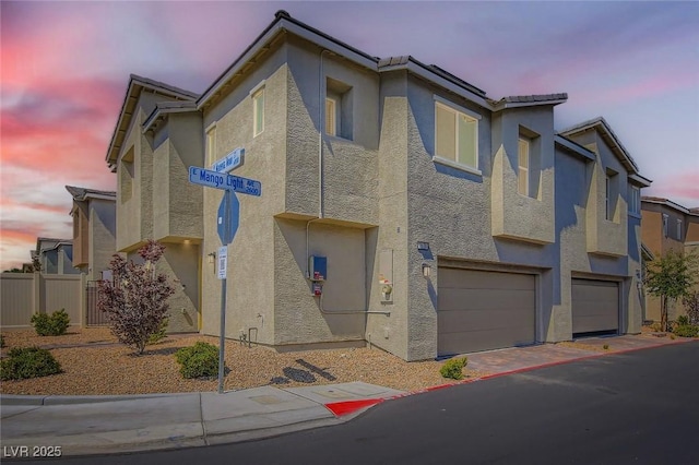 2670 Mango Light Ave, North Las Vegas, NV 89086 - view of front of house with stucco siding, an attached garage, and driveway