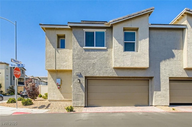 2670 Mango Light Ave, North Las Vegas, NV 89086 - view of front of house featuring stucco siding and an attached garage