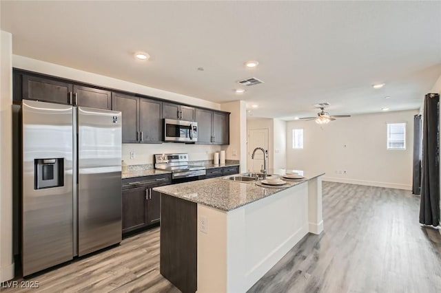 2670 Mango Light Ave, North Las Vegas, NV 89086 - kitchen featuring stainless steel appliances, dark brown cabinetry, light wood-type flooring, a ceiling fan, and recessed lighting
