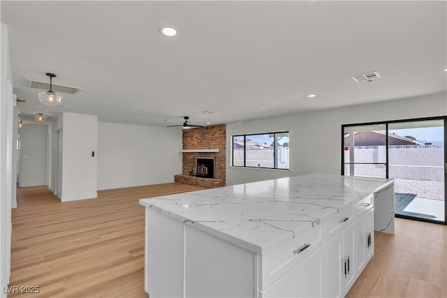 6204 Robin Hood Cir, Las Vegas, NV 89108 - kitchen with ceiling fan, plenty of natural light, a kitchen island, white cabinetry, and recessed lighting