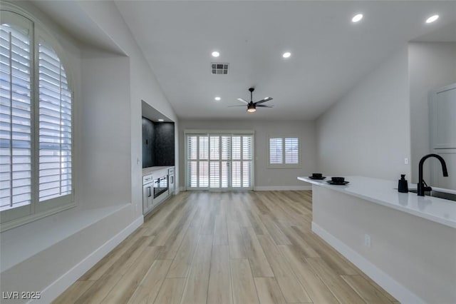 1844 Grand Prairie Ave, North Las Vegas, NV 89032 - unfurnished living room featuring a ceiling fan, light wood finished floors, vaulted ceiling, and recessed lighting