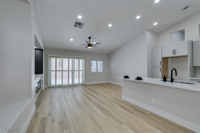 1844 Grand Prairie Ave, North Las Vegas, NV 89032 - unfurnished living room with ceiling fan, light wood-style flooring, lofted ceiling, and recessed lighting