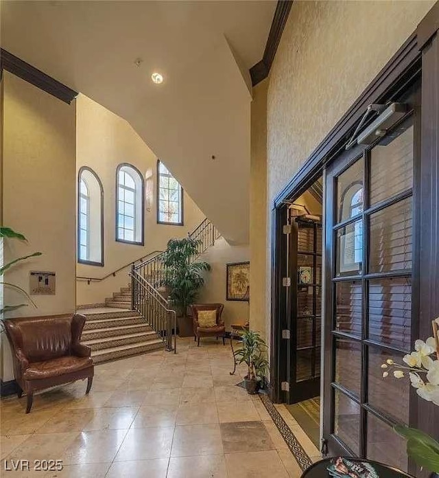 2455 W Serene Ave Unit 620, Las Vegas, NV 89123 - tiled entryway featuring stairway, a high ceiling, and crown molding