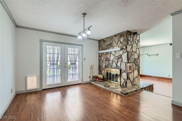 7704 Peacock Ave, Las Vegas, NV 89145 - unfurnished living room with a textured ceiling, crown molding, wood finished floors, and french doors