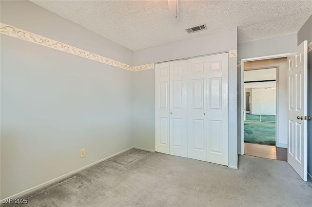 7704 Peacock Ave, Las Vegas, NV 89145 - unfurnished bedroom featuring carpet floors, a closet, and a textured ceiling