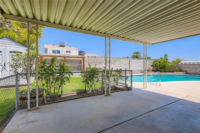 7704 Peacock Ave, Las Vegas, NV 89145 - view of pool with a patio area, a fenced backyard, and a storage unit