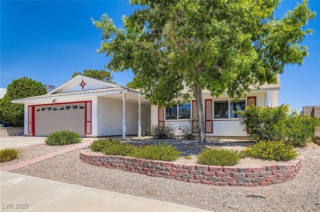 7704 Peacock Ave, Las Vegas, NV 89145 - view of front of home featuring an attached garage, driveway, and stucco siding