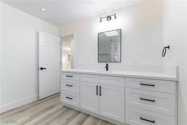 1571 Pawnee Dr, Las Vegas, NV 89169 - bathroom with vanity, wood finished floors, and recessed lighting