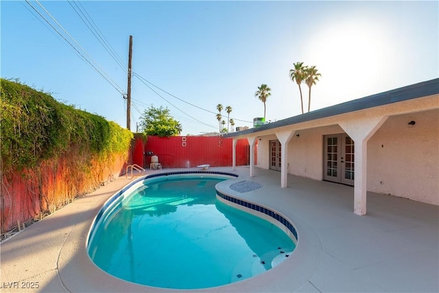 1571 Pawnee Dr, Las Vegas, NV 89169 - view of swimming pool with french doors, a patio area, a fenced backyard, and a diving board