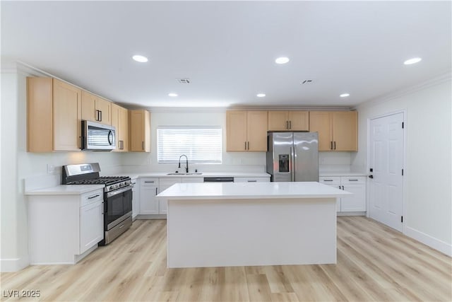 1571 Pawnee Dr, Las Vegas, NV 89169 - kitchen featuring stainless steel appliances, crown molding, a center island, light brown cabinetry, and light countertops