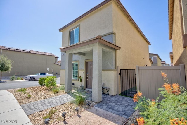 7212 Sunray Point St, North Las Vegas, NV 89084 - view of front of house with stucco siding and a gate