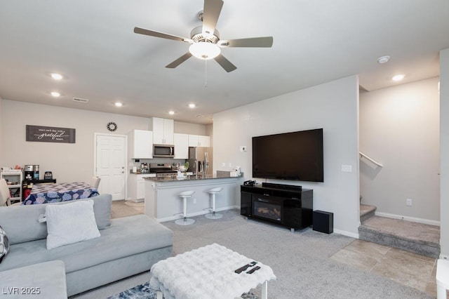 7212 Sunray Point St, North Las Vegas, NV 89084 - living area featuring light colored carpet, stairs, recessed lighting, and a ceiling fan