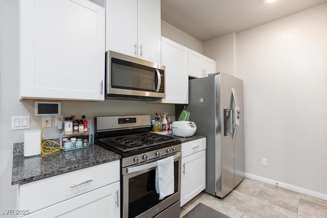 7212 Sunray Point St, North Las Vegas, NV 89084 - kitchen with appliances with stainless steel finishes, white cabinets, and dark stone counters